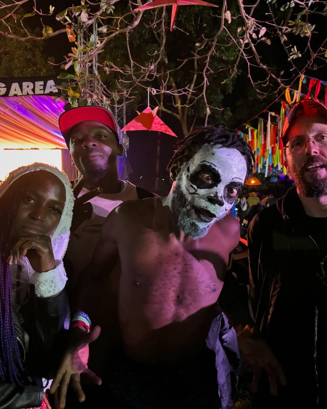 Nyege Nyege festival night — face paint, lights, crowd energy in Uganda